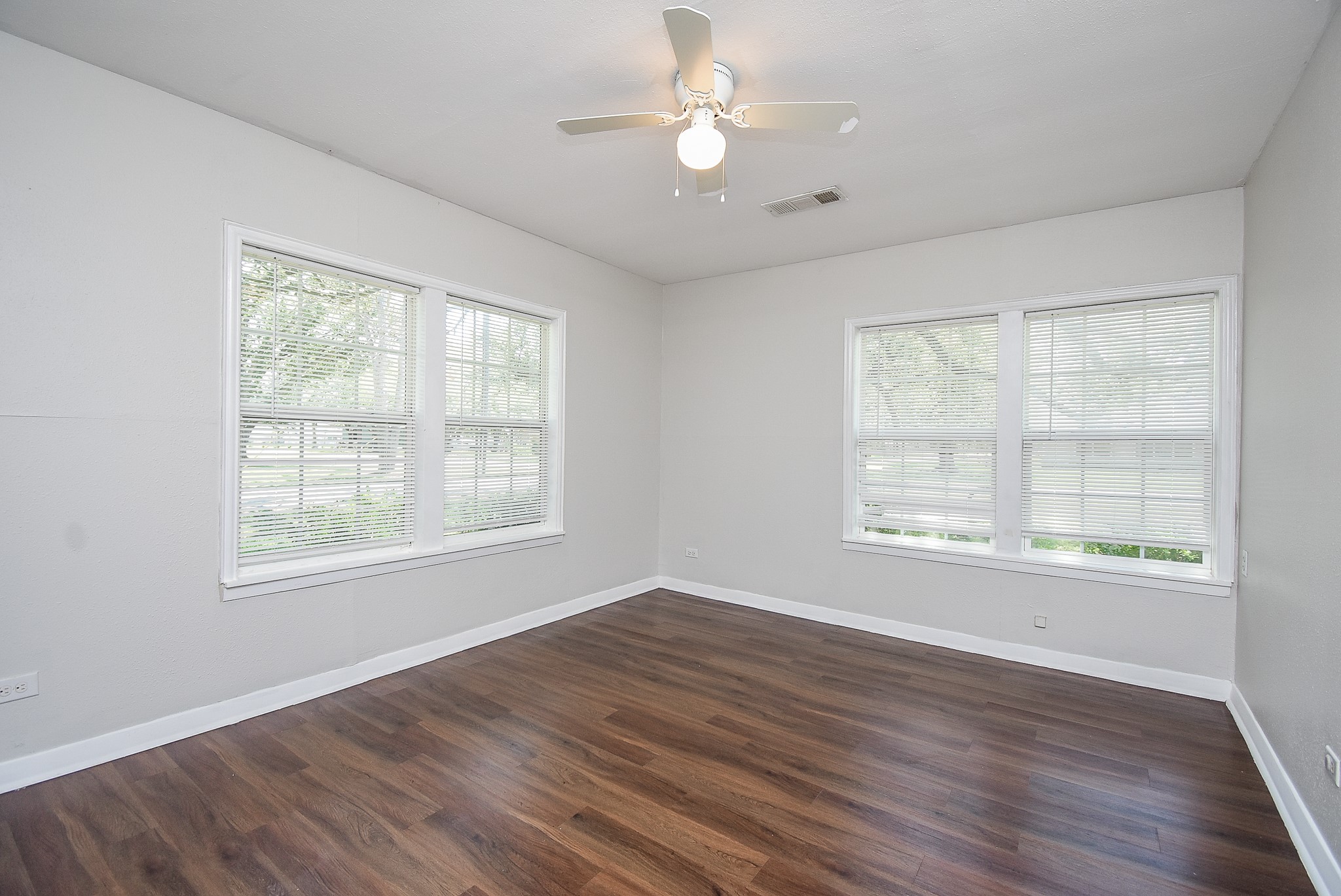 14235 Buffalo Street Needville, TX 77461 - Photo 15 of 21 a view of an empty room with wooden floor and a window