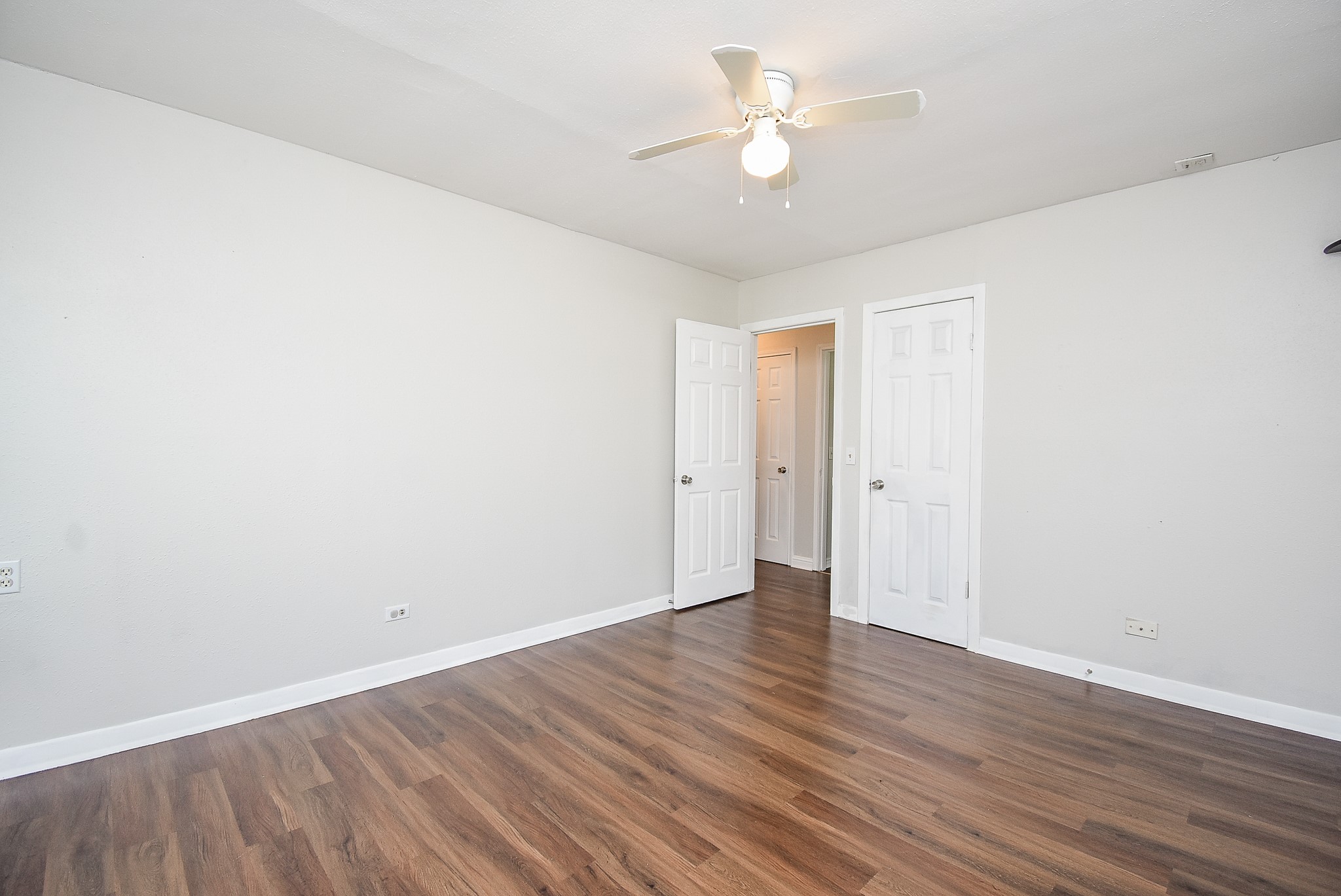 14235 Buffalo Street Needville, TX 77461 - Photo 16 of 21 a view of an empty room with wooden floor