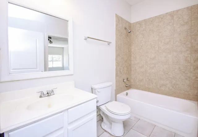 a bathroom with a sink a toilet and a bathtub