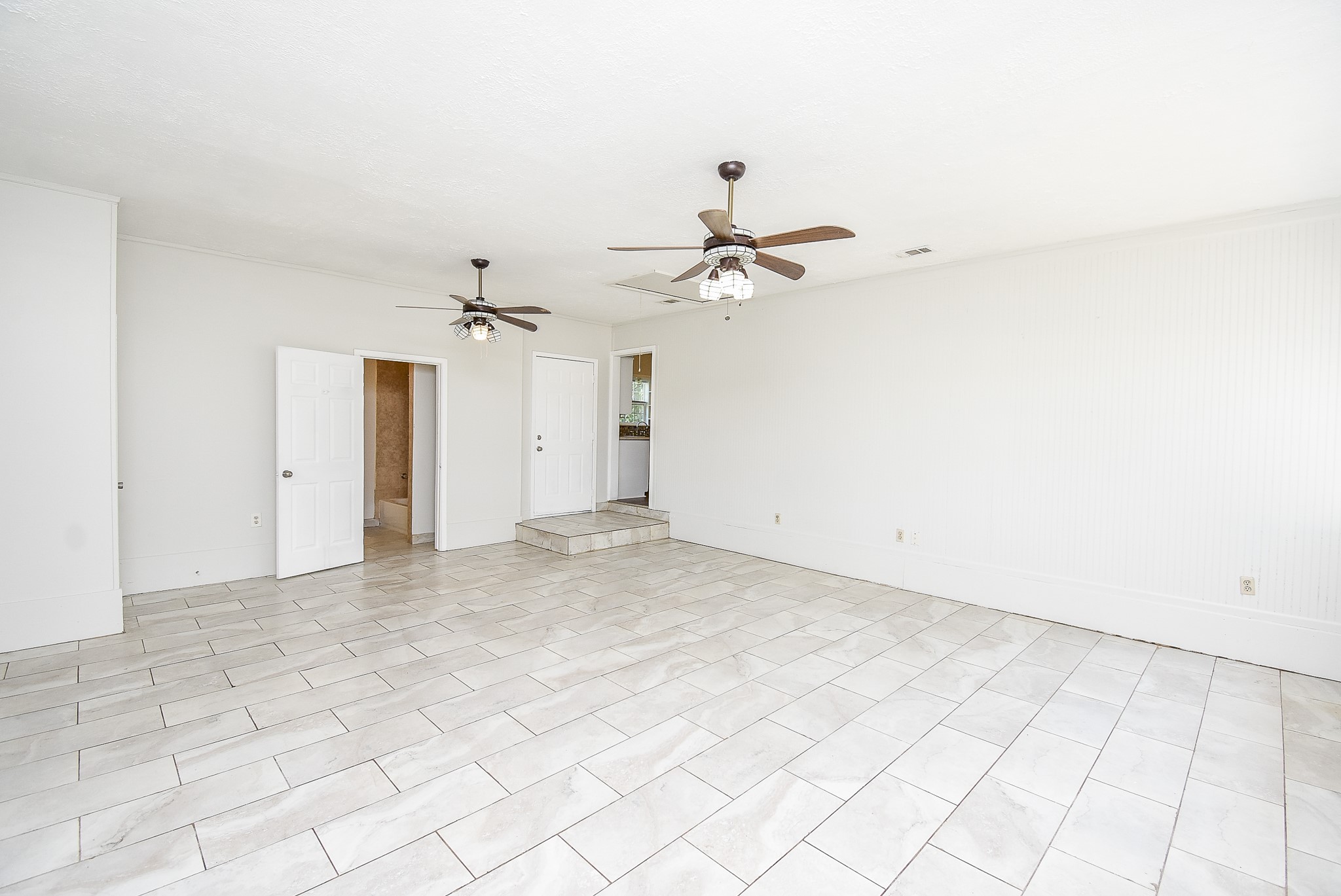 14235 Buffalo Street Needville, TX 77461 - Photo 9 of 21 an empty room with white walls and ceiling fan