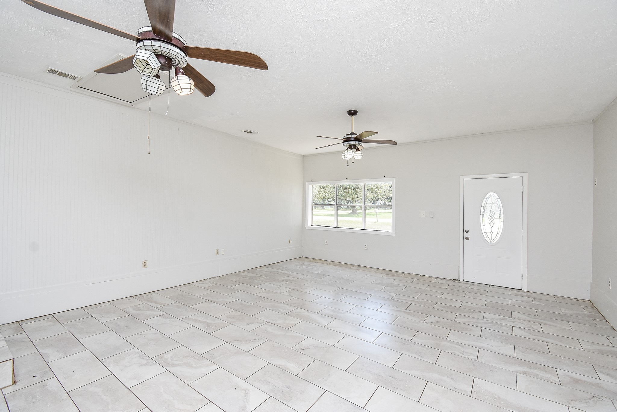 14235 Buffalo Street Needville, TX 77461 - Photo 10 of 21 an empty room with windows and fan