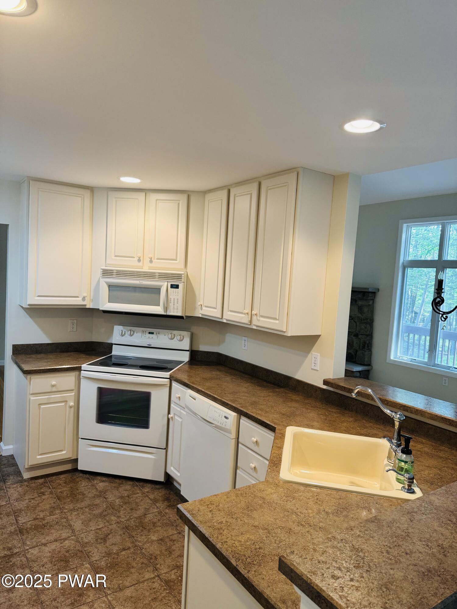 137 Rodeo Drive Hawley, PA 18428 - Photo 4 of 68 a kitchen with kitchen island granite countertop a stove a sink and a granite counter top