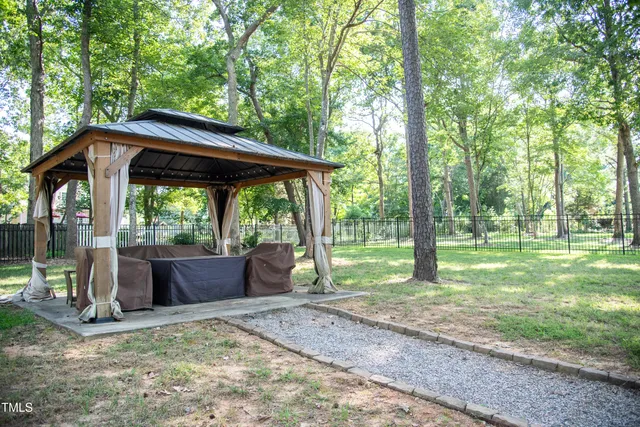a front view of house with a chairs and table in a patio