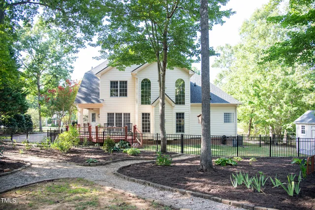 a front view of a house with a yard and a garage