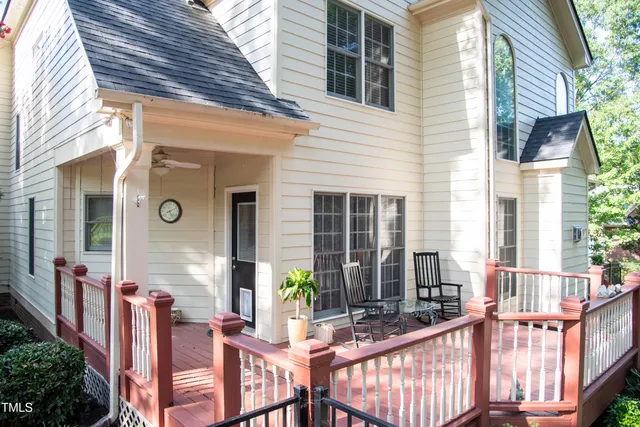 a view of a house with a tree and flower plants