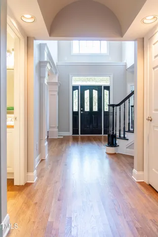 a dining room with furniture wooden floor and a chandelier