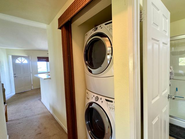 a view of a hallway with washer and dryer