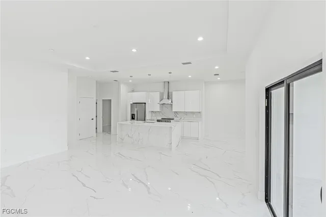 a view of kitchen with white cabinets and stainless steel appliances