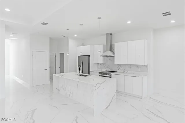 a kitchen with stainless steel appliances a sink stove and cabinets