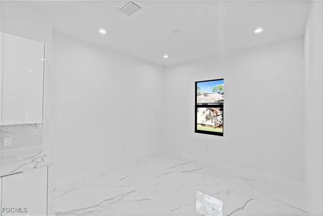 an empty room with a window and closet