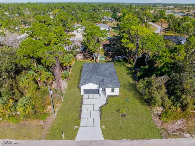 an aerial view of a house with a yard