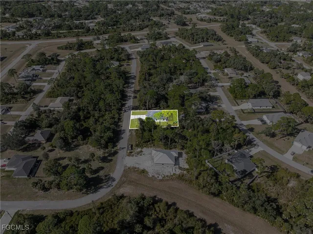 an aerial view of house with yard and outdoor seating