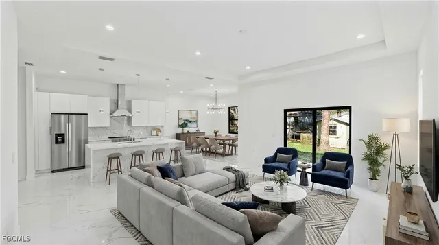 a living room with furniture kitchen and a table