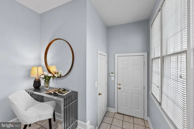 a living room with furniture and a mirror