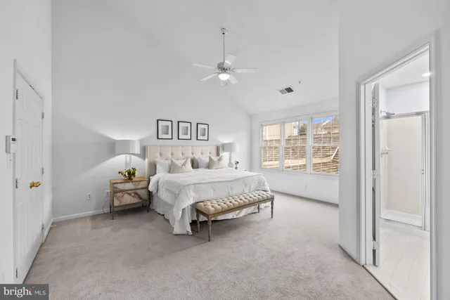 a spacious bedroom with a bed and a window