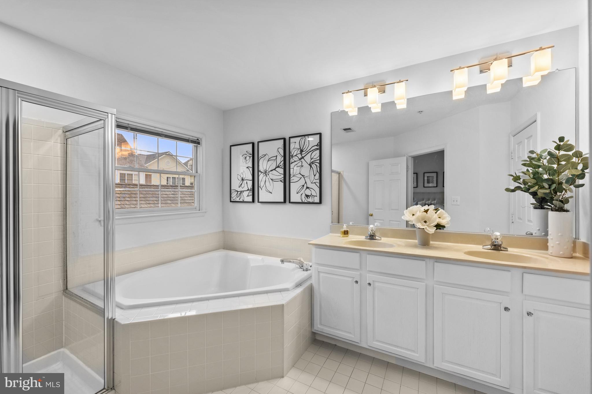 313 Hart Road Gaithersburg, MD 20878 - Photo 22 of 33 a bathroom with a tub a sink and mirror