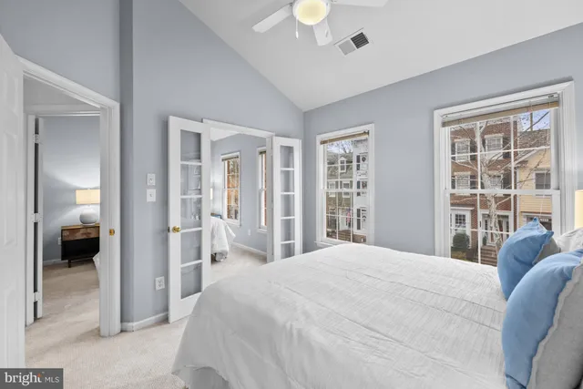 a bedroom with a large bed and a large window