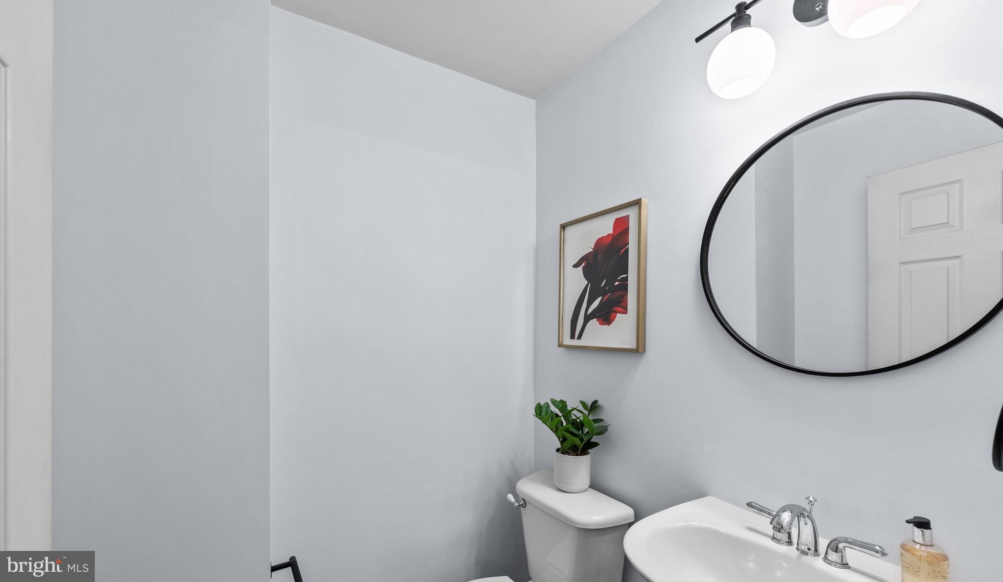 313 Hart Road Gaithersburg, MD 20878 - Photo 8 of 33 a bathroom with a toilet a sink and mirror