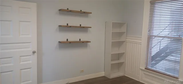 a view of walk in closet with empty racks