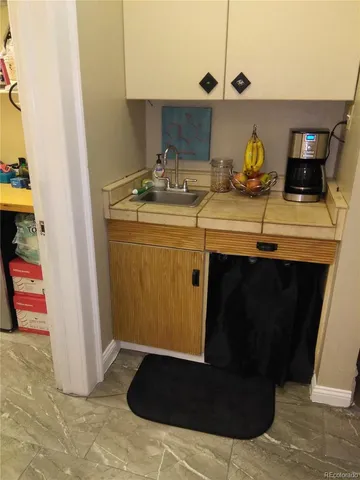 a living room with furniture and a hallway