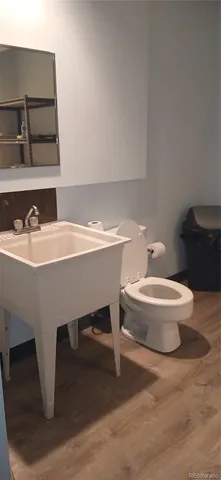 a bathroom with a toilet and a mirror