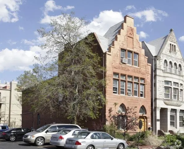 a front view of a residential apartment building with a yard