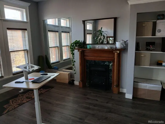 a view of a hallway with wooden floor and furniture
