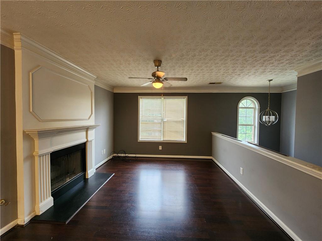 4170 Jewel Terrace Conley, GA 30288 - Photo 2 of 12 a view of an empty room with wooden floor fireplace and a window
