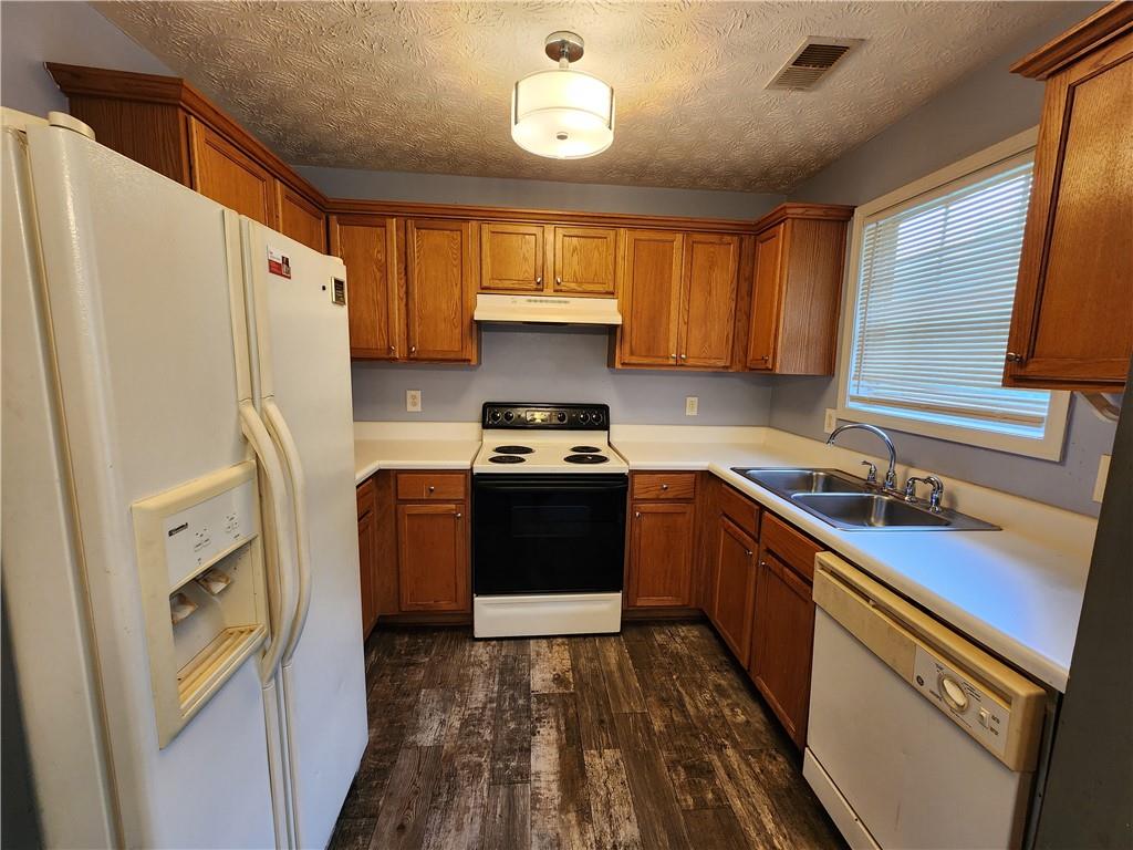 4170 Jewel Terrace Conley, GA 30288 - Photo 3 of 12 a kitchen with a sink a refrigerator and a stove