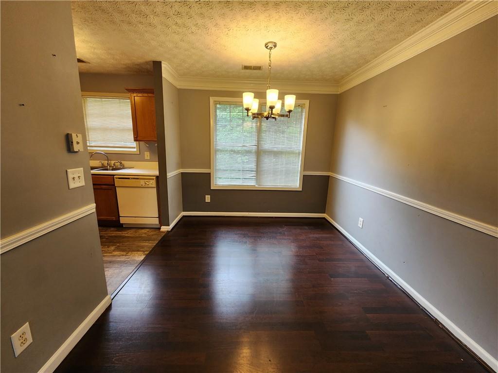 4170 Jewel Terrace Conley, GA 30288 - Photo 4 of 12 an empty room with wooden floor and windows