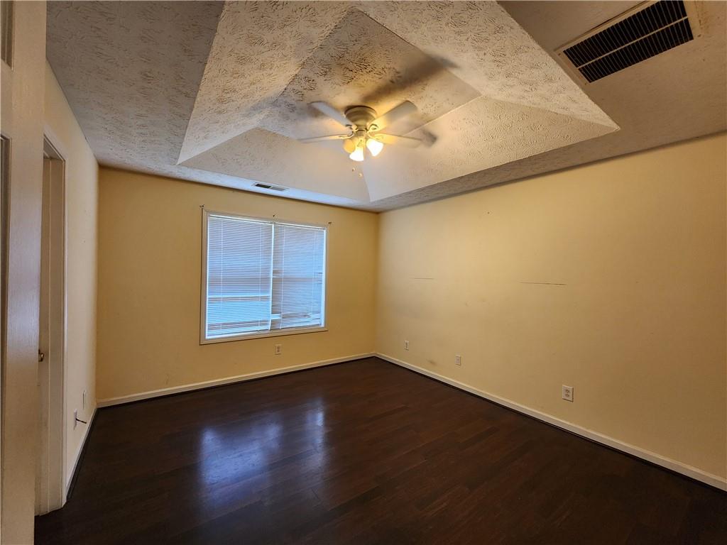 4170 Jewel Terrace Conley, GA 30288 - Photo 5 of 12 a view of an empty room with a window and wooden floor