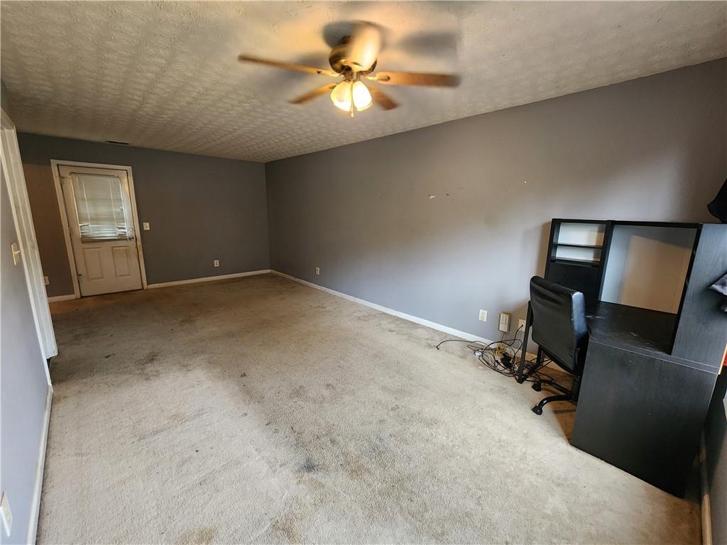 4170 Jewel Terrace Conley, GA 30288 - Photo 9 of 12 a view of a workspace with furniture and a chandelier fan