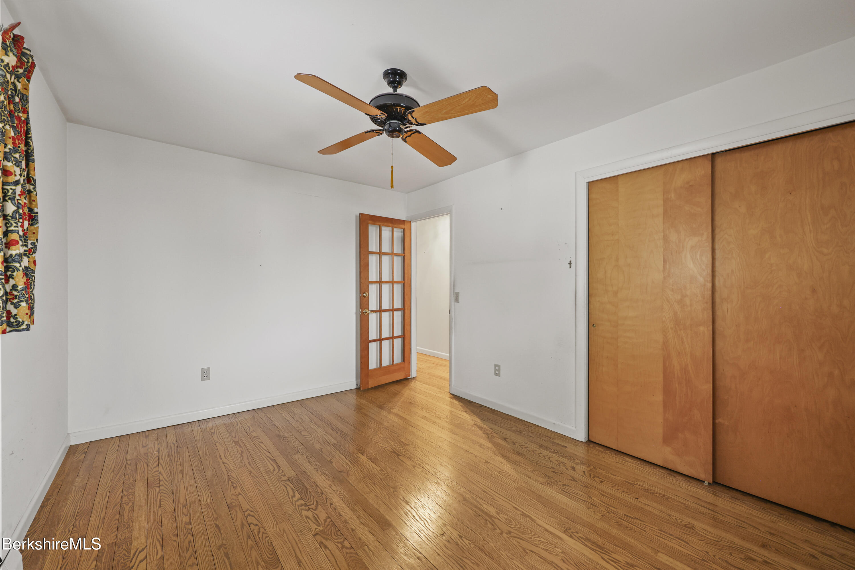 89 Delancy Avenue Pittsfield, MA 01201 - Photo 15 of 40 an empty room with wooden floor closet and windows