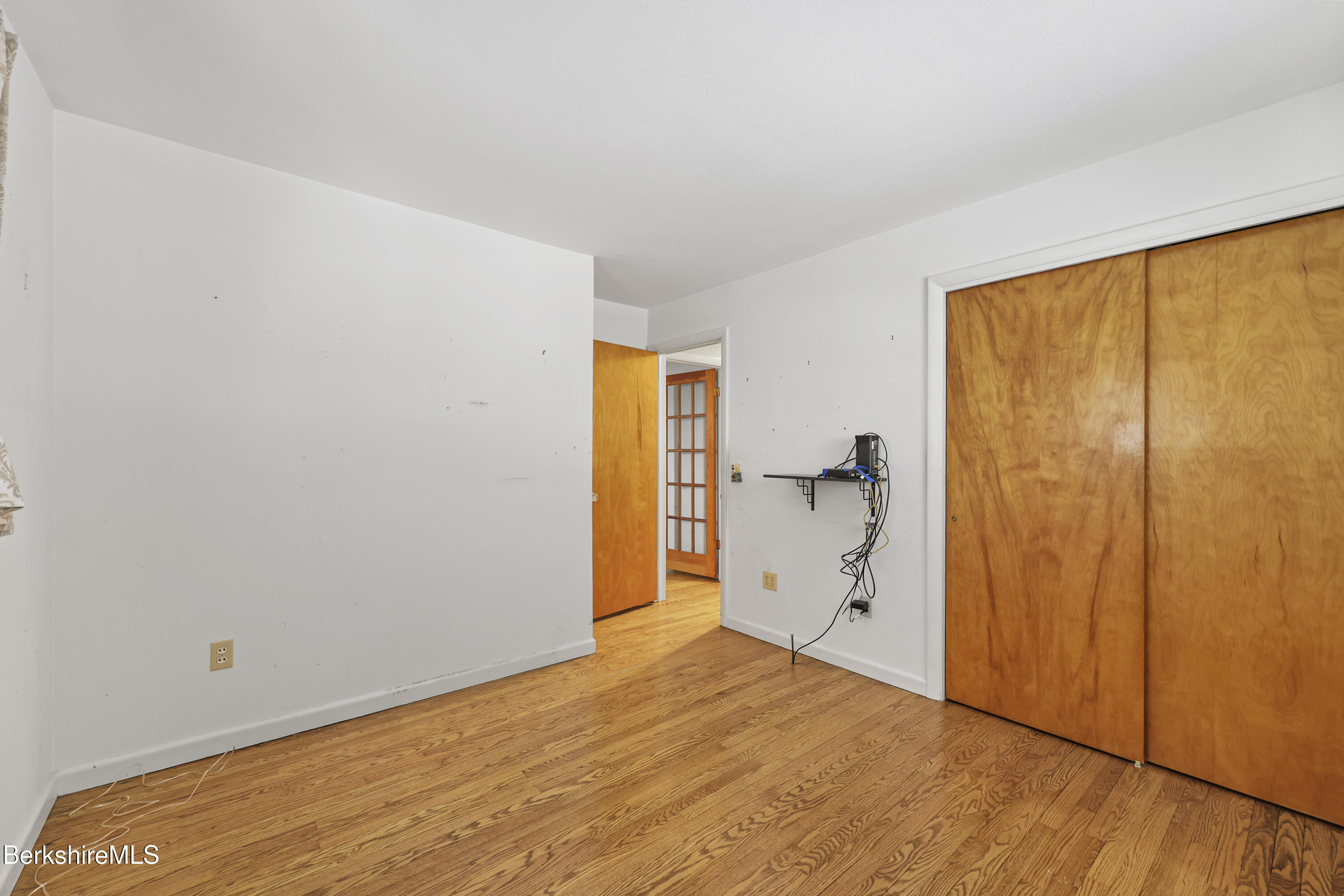 89 Delancy Avenue Pittsfield, MA 01201 - Photo 16 of 40 a view of empty room with wooden floor and fan