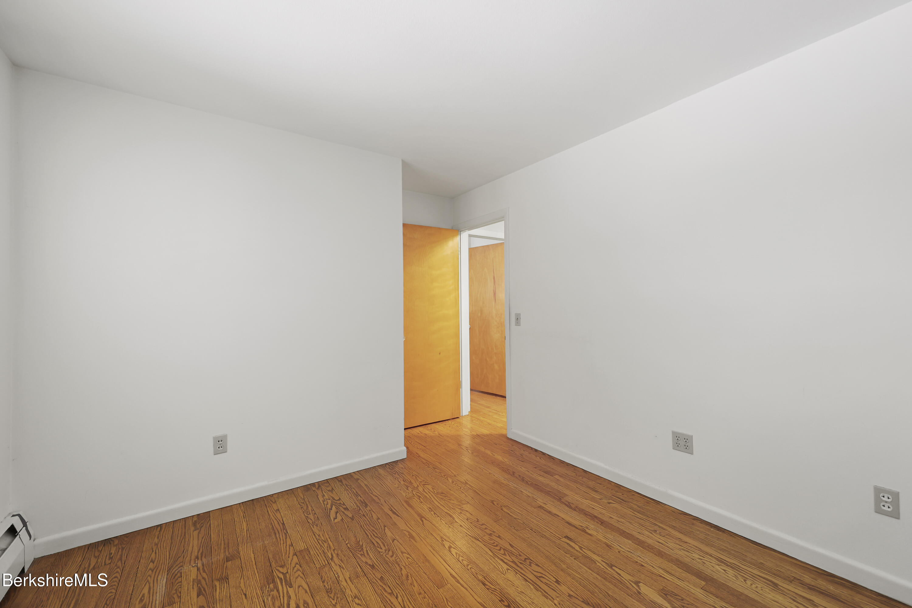 89 Delancy Avenue Pittsfield, MA 01201 - Photo 19 of 40 a view of an empty room with wooden floor and a window