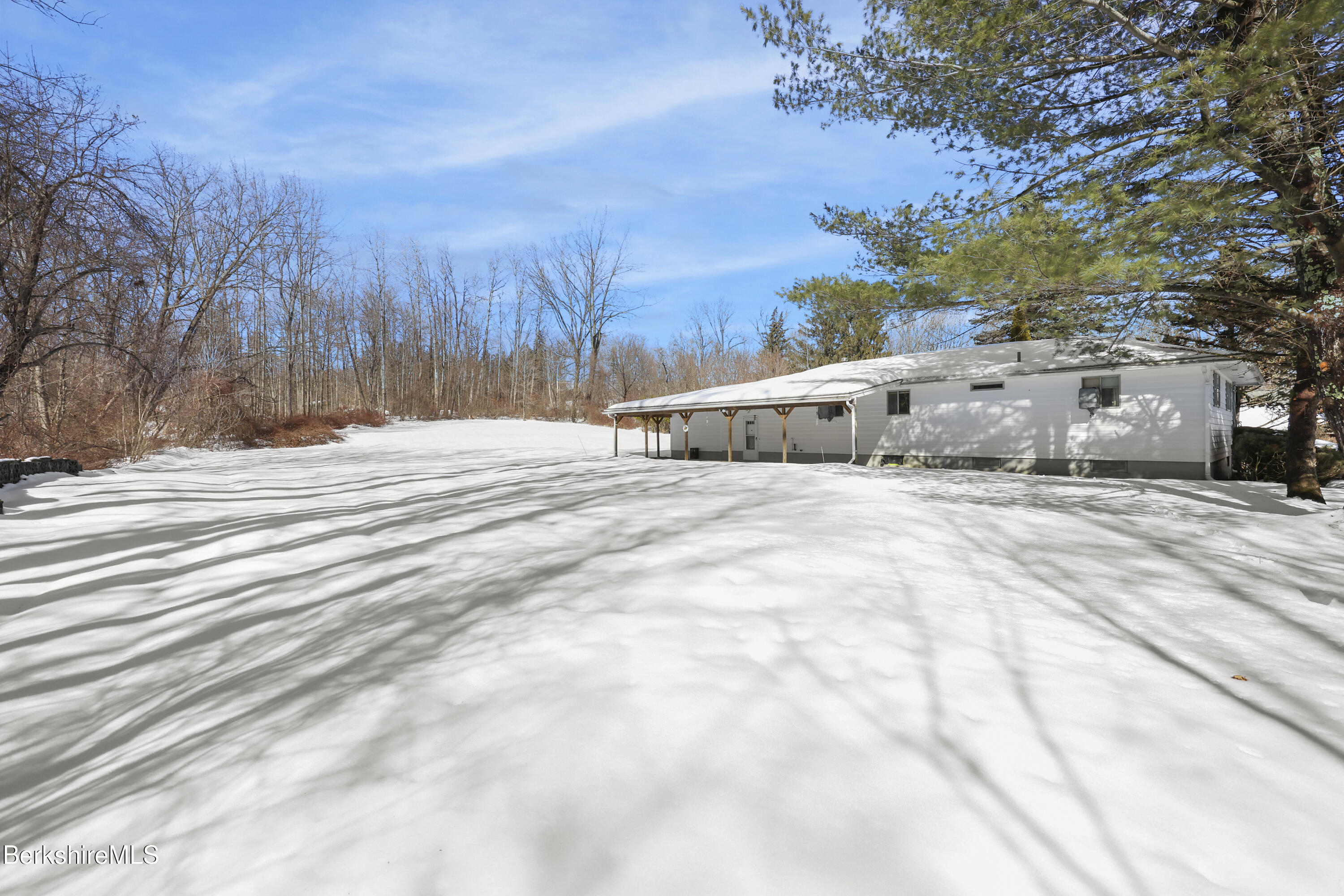 89 Delancy Avenue Pittsfield, MA 01201 - Photo 3 of 40 a view of a white house with a snow on the road