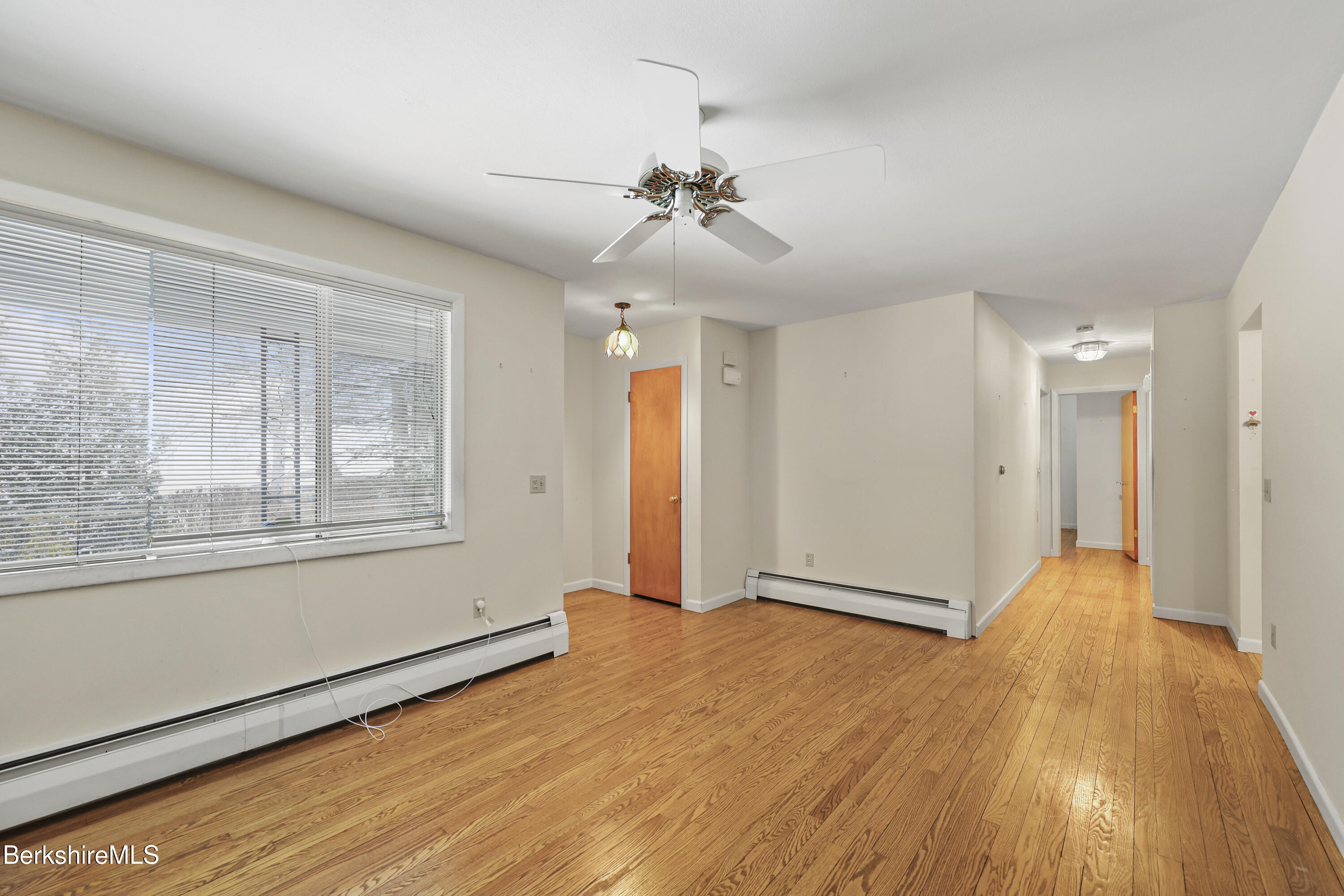 89 Delancy Avenue Pittsfield, MA 01201 - Photo 4 of 40 a view of an empty room with wooden floor and a window