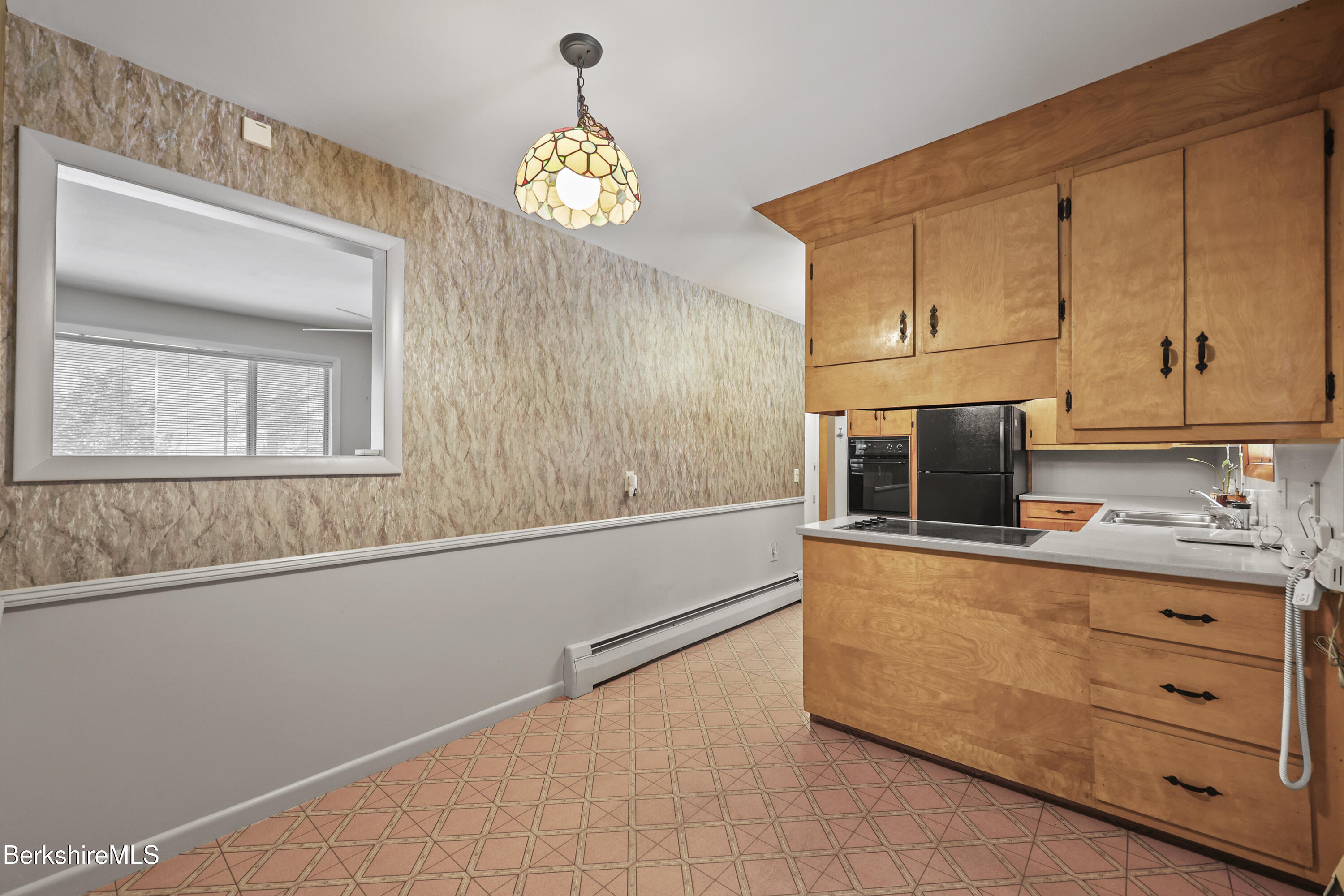 89 Delancy Avenue Pittsfield, MA 01201 - Photo 10 of 40 a kitchen with granite countertop white cabinets and window
