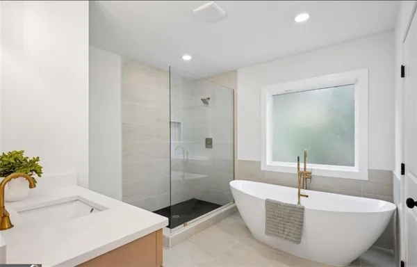 a bathroom with a tub and a sink