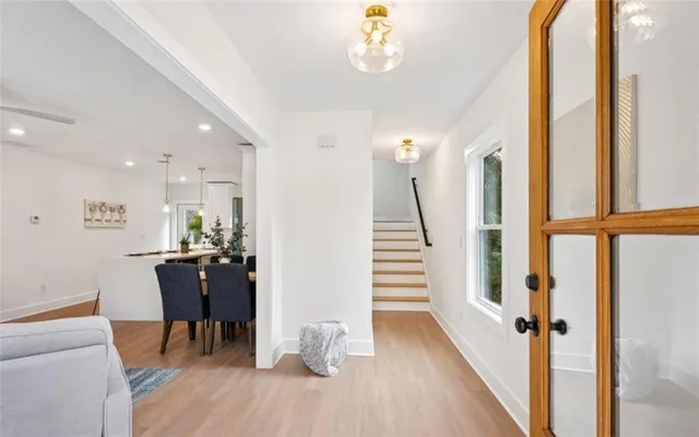 a view of a dining room with furniture a chandelier and wooden floor