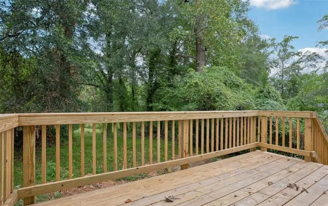 a balcony with wooden floor and fence