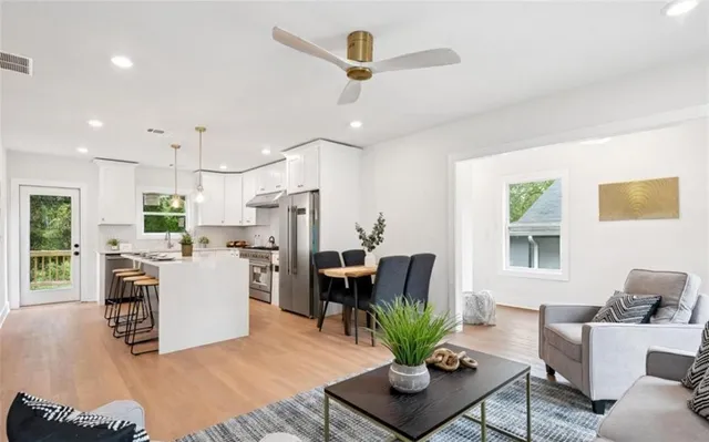 a living room with furniture and kitchen view