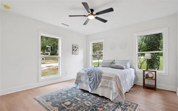 a bedroom with a bed dresser and a window