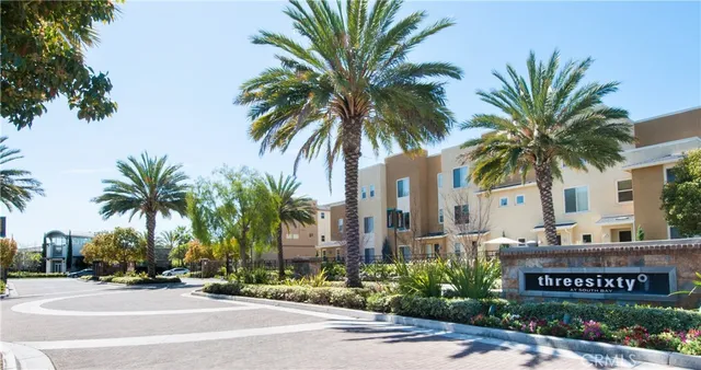 a front view of multi story residential apartment building with yard and sign board