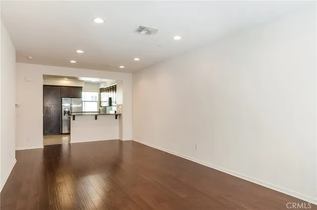 a view of a living room with wooden floor