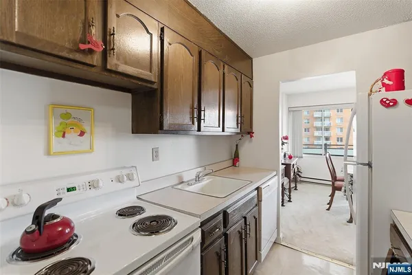 a kitchen with a sink a stove and cabinets