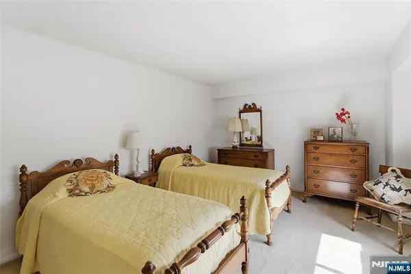 a bedroom with two beds and a chandelier