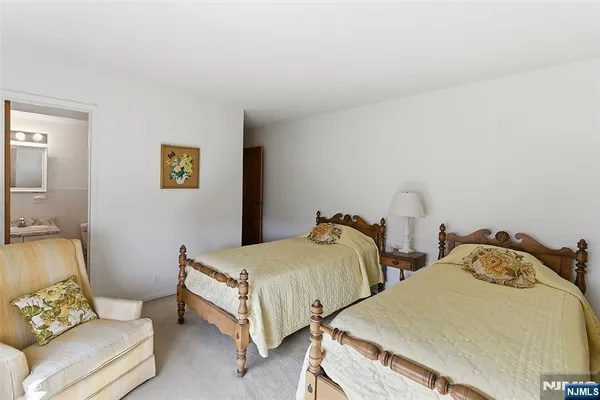 a bedroom with two beds and painted walls