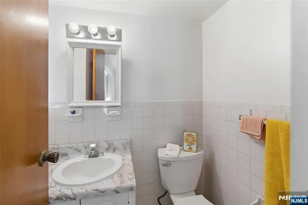 a bathroom with a toilet sink and mirror