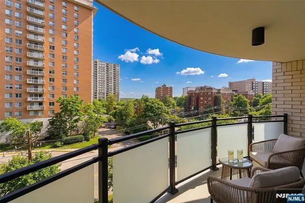 a view of a balcony with couches and wooden floor